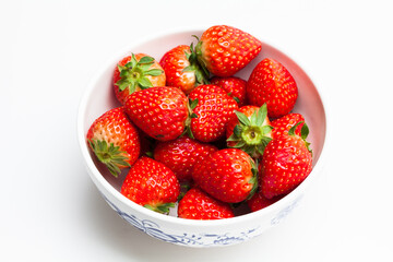 Strawberry in a bowl on a white background.