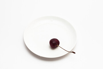 Sweet juicy cherry on a dish isolated
