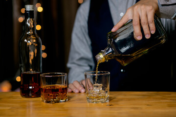 Barman pouring whiskey whiskey glass beautiful night