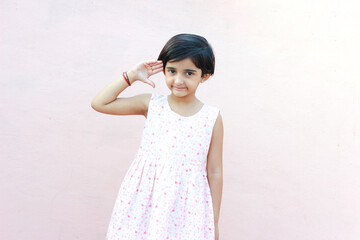 little girl using or showing a sanitizing gel from a bottle for hands cleaning.