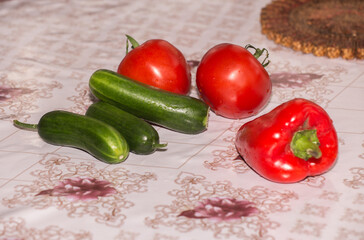 red tomatoes and red pepper lie on the table