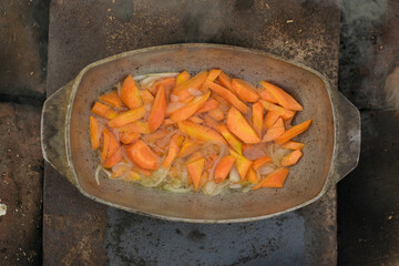 Pilaf in a cauldron with spoon