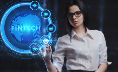 Business, Technology, Internet and network concept. Young businessman working on a virtual screen of the future and sees the inscription: Fintech