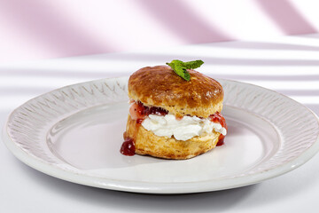 Assortment of homemade scones with ham, cheese, avocado, salmon, cream cheese and strawberry jam