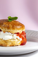 Assortment of homemade scones with ham, cheese, avocado, salmon, cream cheese and strawberry jam