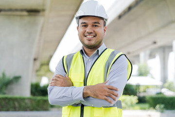 Portrait engineer handsome man or architect looking construction with white safety  helme in...