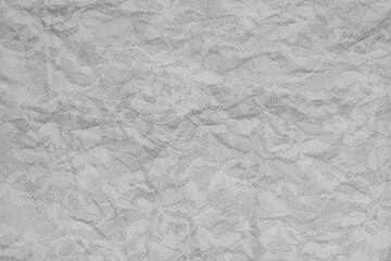 Gray wrinkled textured paper background with lace overlay