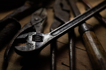 Used adjustable wrench on the shelf with vintage tools.