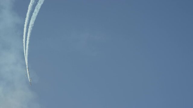 A breathtaking acrobatic loop airshow perform by Airforce Stella leaving an amazing smoke trail in the sky, during the UAE national day