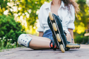Young nice girl skating in park. close up. Resting and fun concept © Nikita