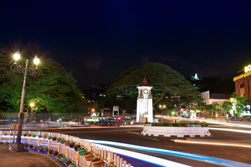 Kandy, Sri Lanka - May 26, 2020: The Famous Clock Tower with the Bahiravakanda buddha statue in the background in the middle of UNESCO World Heritage City of Kandy, Sri Lanka