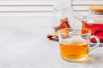 Bael fruit juice or quince tea and dried bael sliced fruit on light gray background. Thai or Asian healthy drink. Bael is helping the body to resist catching a cold