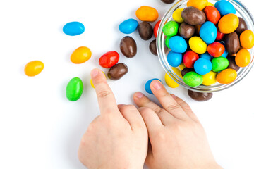 children's hands hold colorful jelly beans