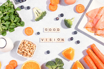 Foods that help maintain eyes healthy, supplements for keeping good vision, vitamins for eyes. Assortment of food for eye health on concrete background, flat lay, top view