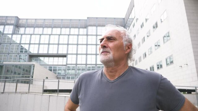 Slow motion shot of senior athletic man looking away