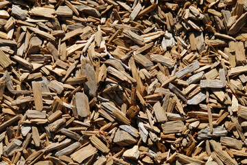 a detailed closeup angle shot view looking down at some shredded wood chip dry mulch ground covering perfect for garden and gardening background as well as nature backdrops