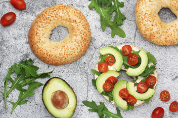 Sesame bagels with tomatoes and avocado