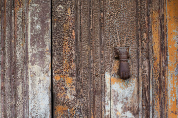old iron knocker on colonial door