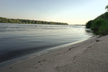 sunrise on the banks of a large river