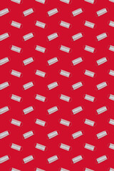 Pattern and medical reusable masks on a red background. Concept of pandemic, epidemic, virus, quarantine.