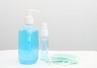Surgical mask, alcohol gel and spray bottle. Concept for new normal items for prevention of Covid-19 disease