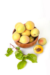 Fresh ripe apricots in wooden bowl isolated on a white background.