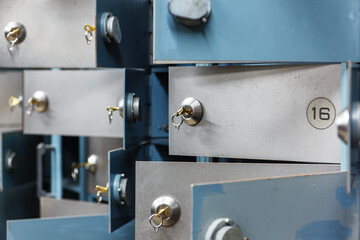 Open doors of deposit boxes with keys in the lock. Bank depository. Soft focus