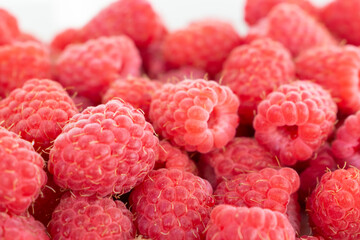 Fresh raspberries background. Close up photo of sweet forest berries.