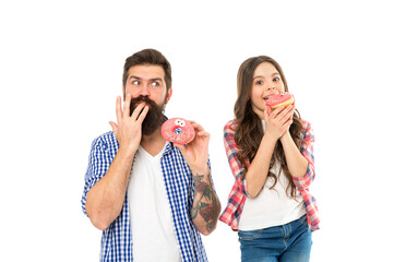 Licking fingers. Bakery shop. Fathers day. Sweet tooth. Girl child and dad hold glazed donuts. Cheerful family. Sweets and treats concept. Daughter and father eat sweet donuts. Happiness and joy