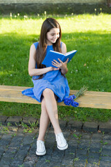 Reading helps your seed of knowledge grow. Little child read book on park bench. Small girl enjoy reading outdoors. Summer reading list. Reading for leisure. Free your imagination, the journey begins