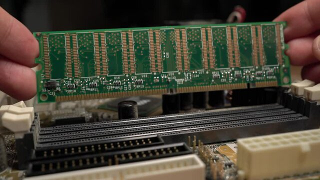 Technician Repairs and installs Computer Ram Memory close up