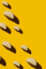 Pattern of tasty marshmallows with hard shadows on a yellow background.