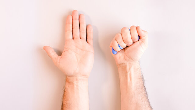 Image 9 of a sequence of images in which a man's hands taking off blue disposable gloves medical. Top view. Selective focus
