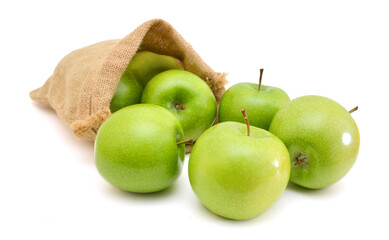 green apples isolated in burlap on white