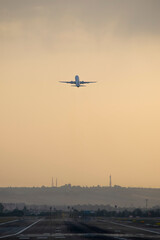 airplane landing at sunset