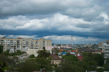 View of the city with big dark clouds. Wallpaper of nature