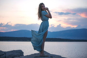 Young beautiful woman at sunset outdoors
