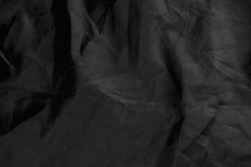 Black wrinkled material with wrinkles and contrasting texture