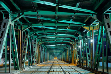Illuminated green metal bridge