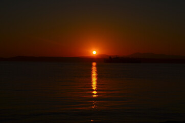 Canakkale with a sunrise and a steamer, morning hours, red colors, sunrise, orange, red, yellow colors
