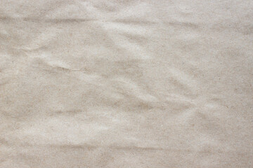 Brown rough crumpled recycled paper texture. Kraft paper background.