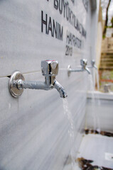 water fountain, running water, drinking water. gray faucet
