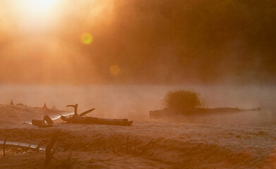 Modern road bridge over the river, bottom view from the water.