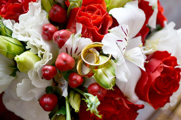 Wedding day, two gold wedding rings on a bouquet, close-up
