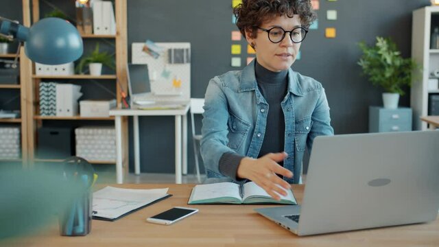 Unhappy woman is using laptop typing not happy about work results then flapping arms and goind away. Failure, modern business and emotions concept.