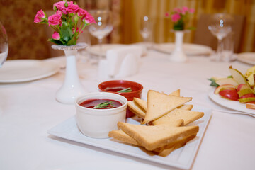 Plate with toasted bread and sauce on table, copy space