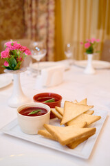 Plate with toasted bread and sauce on table, copy space