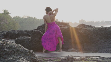 Beautiful woman posing sensually on the beach