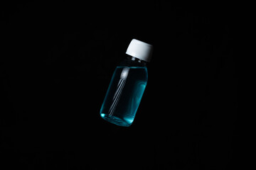 Bottle of antibacterial hand gel on black background