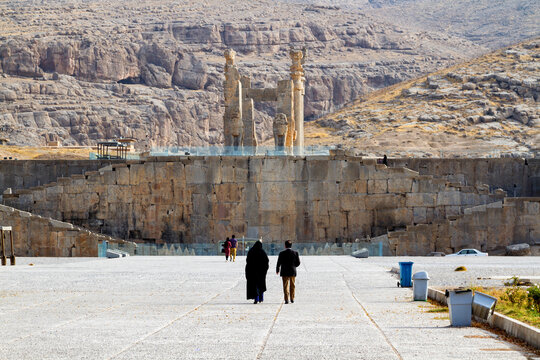 Ruins of Apadana and Tachara Palace behind stairway with bas relief carvings in Persepolis UNESCO World Heritage Site against cloudy blue sky in Shiraz city of Iran. Middle East, Asia